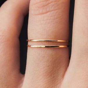 Ultra Thin, 0.7mm thick, super skinny stacking rings worn on the Ring Finger. Featuring the 14k Gold Filled version of this ring with a Smooth, polished finish next to a textured, hammered finish!