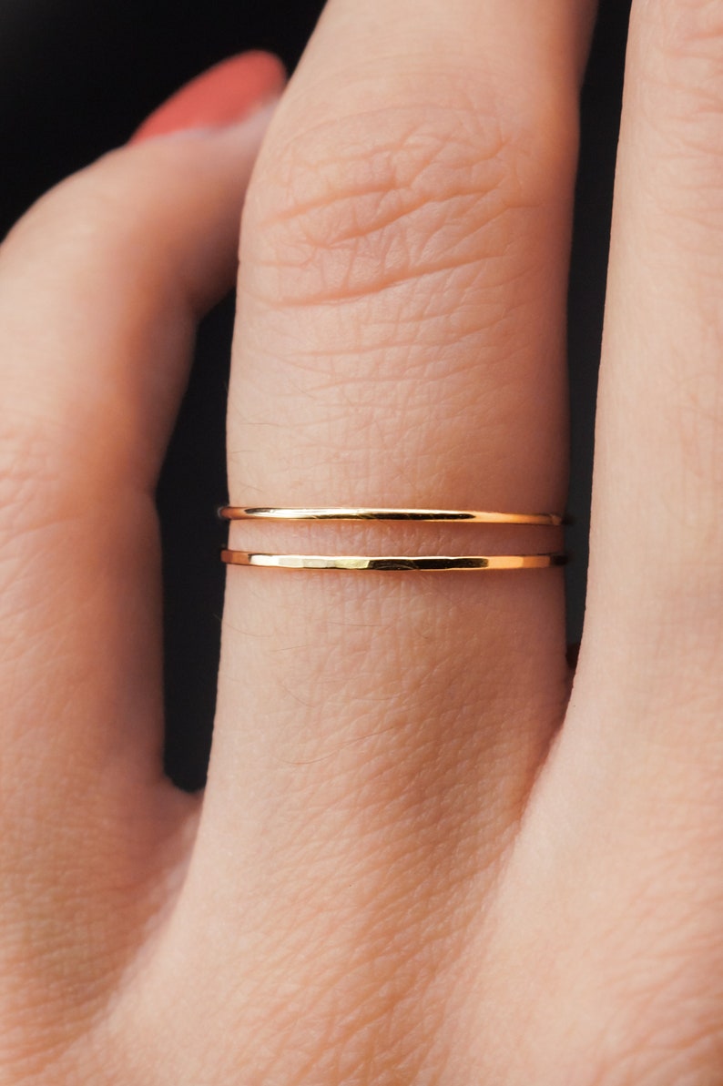 Ultra Thin, 0.7mm thick, super skinny stacking rings worn on the Ring Finger. Featuring the 14k Gold Filled version of this ring with a Smooth, polished finish next to a textured, hammered finish!