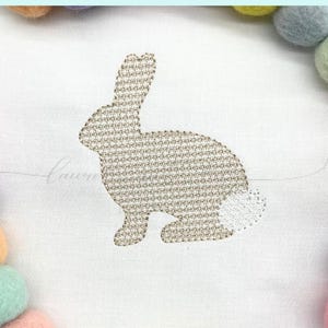 Bunny silhouette with small detail similar to French knot stitching.