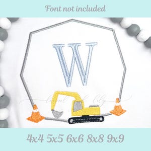 May include: White fabric with a gray geometric border, featuring a light blue letter "W" and a yellow excavator. Two orange traffic cones flank the excavator. Text at the top reads "Font not included". Below, text indicates sizes.