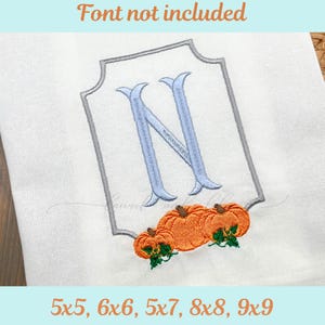 May include: White fabric with a gray framed design, a light blue letter "N", and three orange pumpkins with green leaves. The text "Font not included" is at the top. The text "5x5, 6x6, 5x7, 8x8, 9x9" is at the bottom.