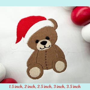 May include: Embroidered brown teddy bear wearing a red and white Santa hat. The bear has a black nose and smiling mouth. The image shows the bear in various sizes: 1.5, 2, 2.5, 3, and 3.5 inches.