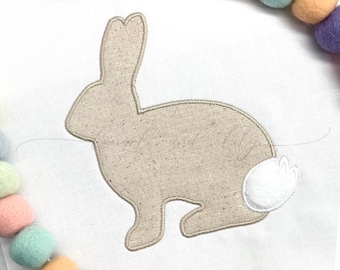 May include: A beige bunny silhouette with a white fluffy tail. The bunny is sitting on a white background. The image includes the text "4x4 5x7 6x6 8x8".
