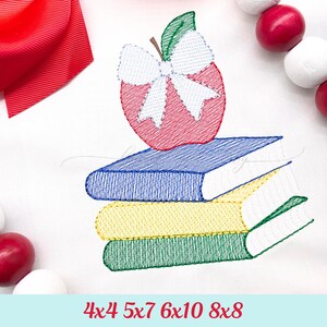 May include: An embroidered design featuring a red apple with a white bow on top of a stack of three books. The books are blue, yellow, and green. The text at the bottom reads "4x4 5x7 6x10 8x8".