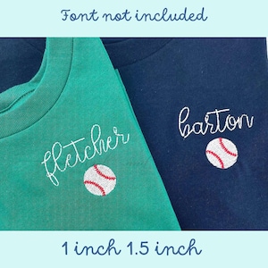 May include: Two t-shirts with embroidered names and baseballs. The green t-shirt has "fletcher" embroidered on it and the navy blue t-shirt has "barton" embroidered on it. Both shirts have a white baseball with red stitching embroidered below the name. The shirts are laid out on a surface with the text "1 inch 1.5 inch" below them.