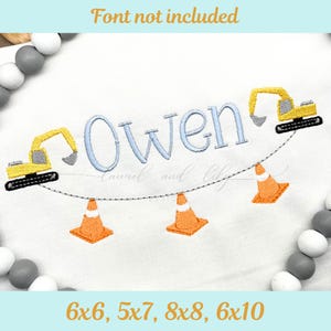 May include: White fabric embroidered with the name "Owen" in light blue script, flanked by yellow construction vehicles and orange traffic cones. The text "Font not included" is at the top.