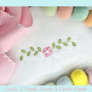 May include: White fabric with a pink embroidered flower and green leaves. A pink ribbon and colorful felt balls are in the background. The text at the bottom reads: 2 inch, 2.5 inch, 3 inch, 3.5 inch, 4 inch.