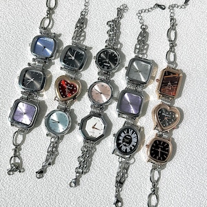 May include: A set of ten silver-toned wristwatches with different face designs, including square, round, heart, and octagonal shapes. The watches have various colored faces, including black, white, pink, and purple.