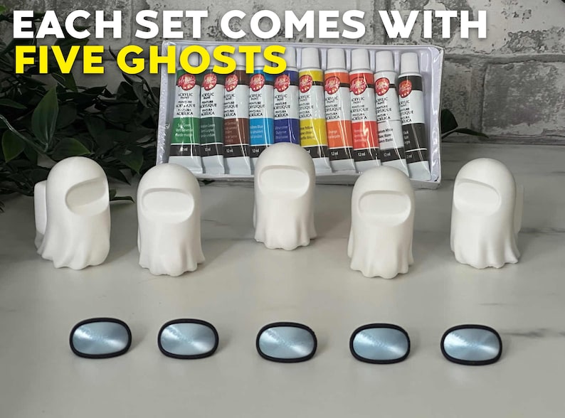 May include: Five white ghost-shaped figurines with black eyes and a black mouth. The figurines are arranged in a row on a white surface. There are ten tubes of acrylic paint in the background. The text "EACH SET COMES WITH FIVE GHOSTS" is visible at the top of the image.