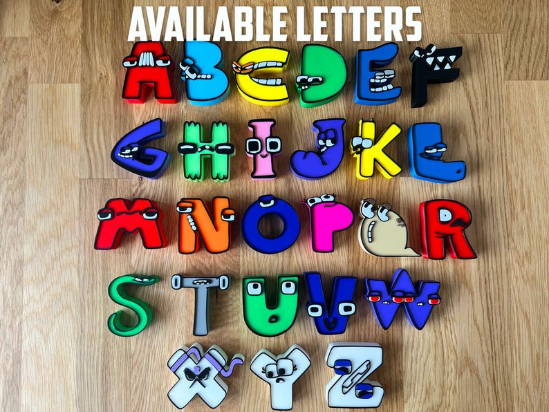 May include: Colorful alphabet letters in various colors, including red, blue, yellow, and green, arranged on a wooden surface. The letters have cartoon-like features and the text "AVAILABLE LETTERS" is at the top.