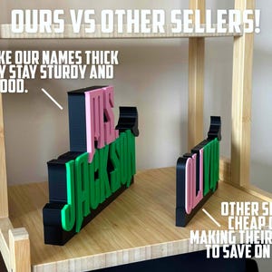 May include: A comparison of two custom-made name signs. The sign on the left is thick and sturdy, with the name "Mrs. Jackson" in pink and green letters. The sign on the right is thin and flimsy, with the name "Olivia" in pink and green letters. The text "OURS VS OTHER SELLERS!" is at the top of the image. The text "WE MAKE OUR NAMES THICK SO THEY STAY STURDY AND LOOK GOOD." is below the left sign. The text "OTHER SELLERS CHEAP OUT BY MAKING THEIR'S THIN TO SAVE ON COSTS." is below the right sign.