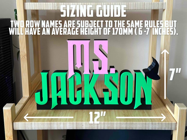 May include: A green and pink wooden sign with the text "MS. JACKSON" and a witch's hat. The sign is 12 inches wide and 7 inches tall.