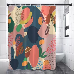 May include: A colorful shower curtain with an abstract design. The curtain features large shapes in shades of pink, blue, green, and yellow, with black line art and dotted patterns. The curtain is hanging in a bathroom.