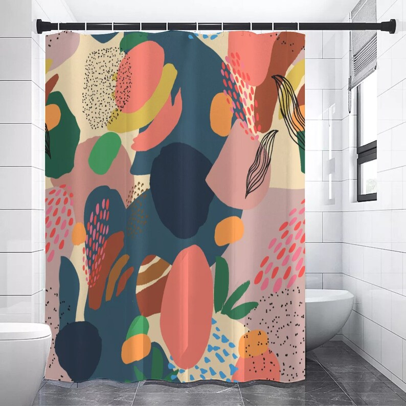 May include: A colorful shower curtain with an abstract design. The curtain features large shapes in shades of pink, blue, green, and yellow, with black line art and dotted patterns. The curtain is hanging in a bathroom.