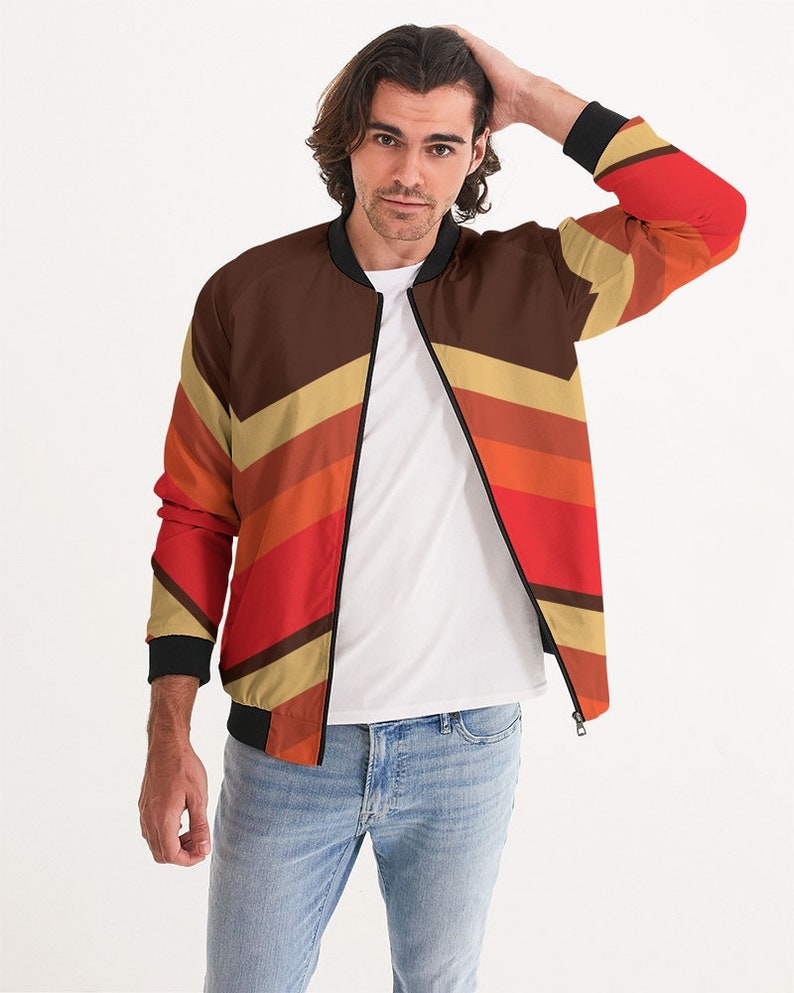 May include: A brown, red, and beige bomber jacket with a striped pattern. The jacket has a zipper closure and a ribbed collar.