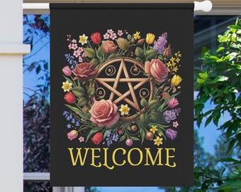 May include: Black welcome flag featuring a wooden pentagram surrounded by a floral wreath of roses, tulips, and other flowers. The word "WELCOME" is displayed in gold lettering at the bottom. A decorative garden flag for outdoor use.