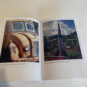 May include: Open book with two color photographs. The left image shows a weathered yellow truck. The right image shows a rocket-shaped structure on a miniature golf course. Text at the bottom of each image reads "Maggie Valley, NC, July, 2025, Ilford Color 400."