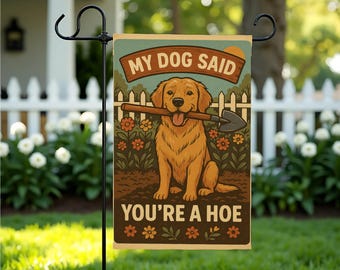 May include: A garden flag with a cartoon golden retriever holding a shovel in its mouth. The flag has the text "My Dog Said You're A Hoe" on it.