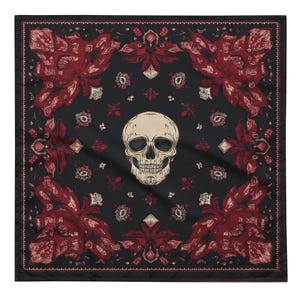 May include: Black square bandana with a cream-colored skull in the center. The bandana features a repeating pattern of red floral designs and decorative elements against a black background. The edges are finished with a detailed border.