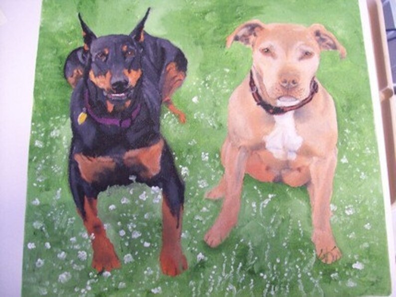 May include: A watercolor painting of two dogs sitting on a green grassy field. The dog on the left is a black and brown Doberman Pinscher, and the dog on the right is a light brown Pit Bull Terrier.