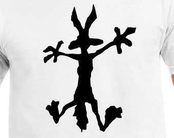 May include: White t-shirt with a black silhouette of a cartoon coyote in a dynamic pose. The coyote has outstretched arms and legs, with a stylized, minimalist design. The shirt is made of a soft, white fabric.