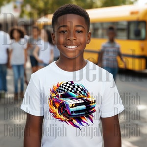 May include: A young boy wearing a white t-shirt with a colorful graphic of a race car with flames and a checkered flag.