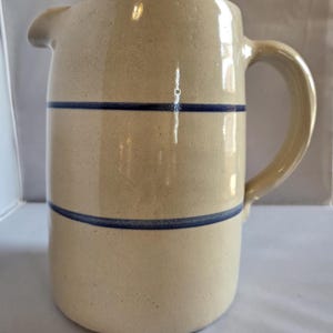 May include: A set of three ceramic mugs with a speckled, matte finish. The mugs are in shades of cream, light gray, and dark gray. Each mug has a simple, minimalist design, perfect for coffee or tea.