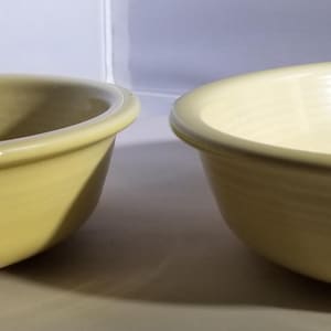 Cream colored early Fiestaware bowls made by Homer Laughlin Company