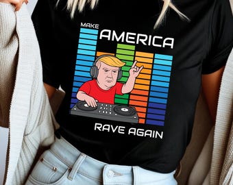 May include: Black t-shirt with a graphic of a cartoon figure wearing headphones and operating DJ equipment. The text reads "MAKE AMERICA RAVE AGAIN" in white capital letters above and below the graphic.