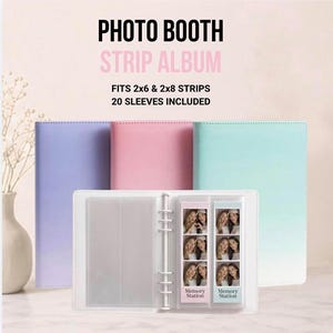 May include: A photo booth strip album with three solid-colored covers in lavender, pink, and mint green. The open album features clear plastic sleeves holding two photo strips. Text reads: PHOTO BOOTH STRIP ALBUM, FITS 2x6 & 2x8 STRIPS, 20 SLEEVES INCLUDED.