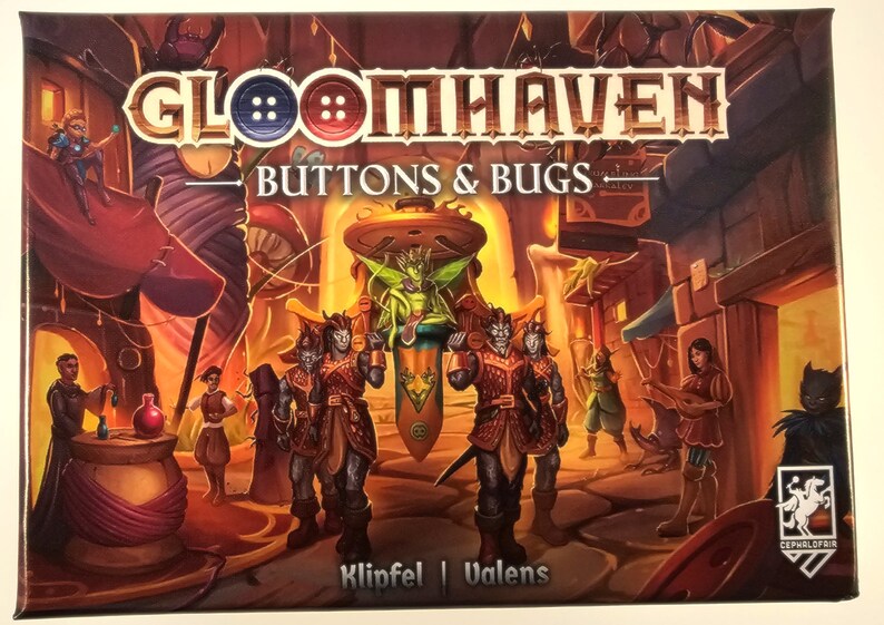May include: A board game box cover featuring a fantasy scene with a green fairy-like creature on a throne, surrounded by four characters with red and brown clothing. The box cover is titled "Gloomhaven: Buttons & Bugs" and features the Cephalofair Games logo.