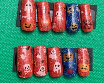 May include: Set of ten Halloween-themed press-on nails with glitter finish. The nails feature various designs including ghosts, pumpkins, skulls, and candy corn.