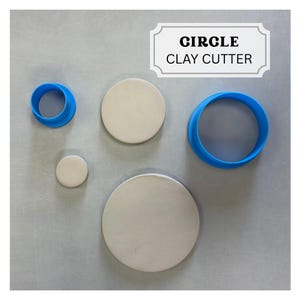 May include: A set of circle clay cutters and clay circles. The cutters are bright blue, and the clay circles are a light beige color. The text "CIRCLE CLAY CUTTER" is in a white rectangle.