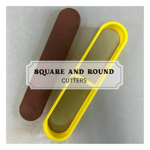 May include: A long, dark brown rectangular tool with rounded ends positioned next to a bright yellow, elongated oval-shaped cutter frame. A central label with a decorative border displays the black text SQUARE AND ROUND CUTTERS.