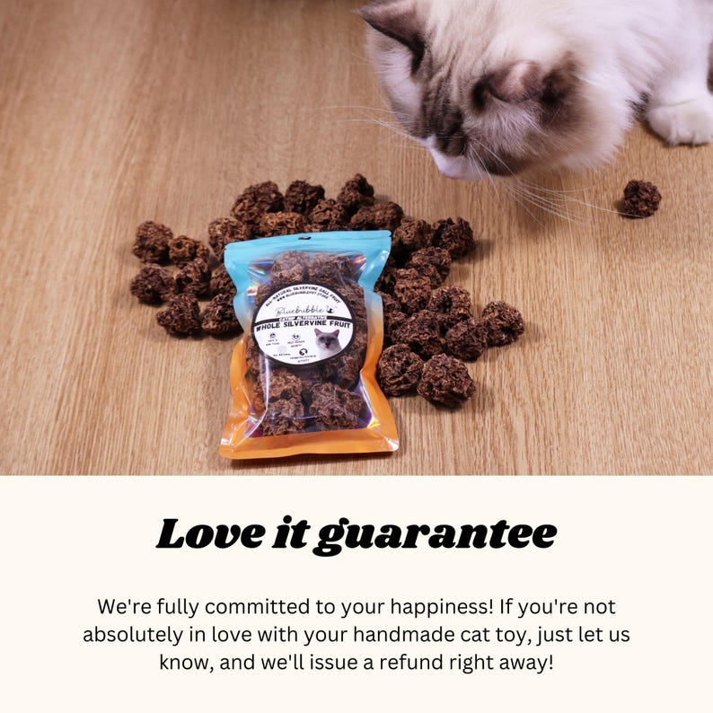 May include: A close-up of a bag of brown, dried catnip treats. The bag is labeled "Silvervine Fruit" and has a picture of a cat on it. A cat is sniffing the treats on a wooden surface.