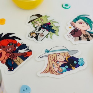 May include: Four die-cut vinyl stickers featuring anime-style characters. One shows a person with orange hair hugging a small creature, another a person with light green hair and a cap, a third with teal hair, and one with blonde hair wearing a hat.