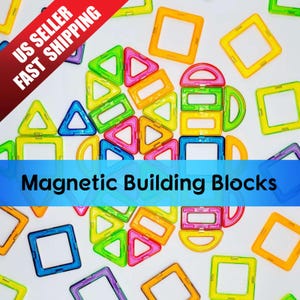 May include: A set of colorful magnetic building blocks in various shapes, including squares, triangles, and arches. The blocks are made of plastic and have a glossy finish. The blocks are arranged in a pattern on a white surface. Magnetic Building Blocks.