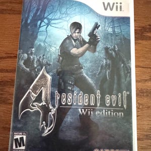 May include: A white plastic video game case for the Nintendo Wii featuring the game Resident Evil 4 Wii Edition. The cover art displays a character holding a handgun in a dark forest setting with figures in the background, the ESRB M rating, and Capcom logo.