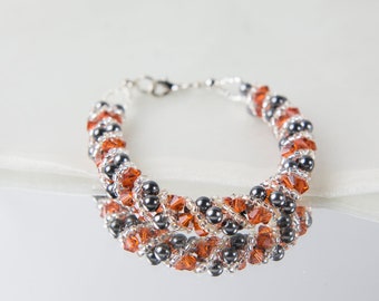 Crystal swarovski bracelet; glass bracelet; Orange and black twisty swarovski bracelet, size 7.5 inches and 2 inches adjustable chain