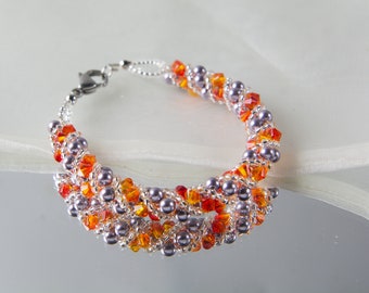 Crystal swarovski bracelet; glass bracelet; Orange and purple twisty swarovski bracelet, size 7 inches and 2 inches adjustable chain