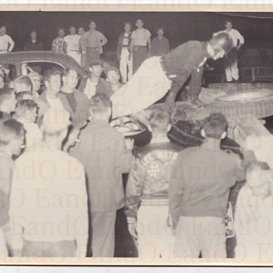 Vintage Photo &quot;After the Crash&quot; Awesome Vintage Photos of a Man Climbing Out of a Race Car at a Demolition Derby or Other Car Race Event