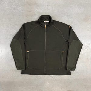 May include: A set of three ceramic mugs with a speckled, matte finish in cream, light grey, and dark grey. Each mug has a simple, modern design and a rounded handle.