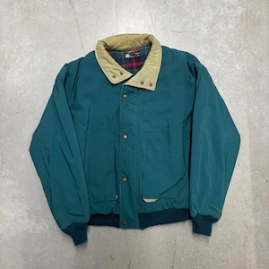 May include: Teal jacket with a tan collar and plaid lining. The jacket features a button-up front, two front pockets, and ribbed cuffs and hem. A classic style, suitable for cooler weather. The jacket's measurements are in centimetres.