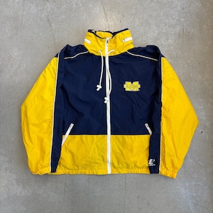 May include: A navy blue and yellow windbreaker jacket featuring a high collar with a drawstring, a full-length white front zip, and two zipped pockets. The chest displays a yellow block M logo with the word Michigan printed inside.