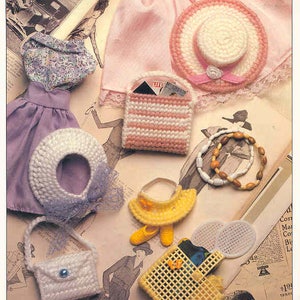 May include: A collection of doll accessories, including a crocheted hat, purse, and dress. The image also features a yellow visor, shoes, and a woven basket. The text "DOLL ACCESSORIES" is visible at the top.