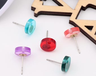 May include: Five pairs of colorful stud earrings. The earrings are round and have a shiny finish. The colors are turquoise, red, purple, pink, and green.