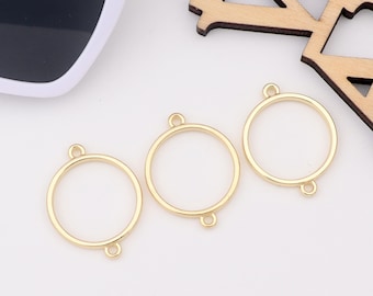 May include: Three gold-coloured metal rings with jump rings. The rings are round and have a smooth finish.