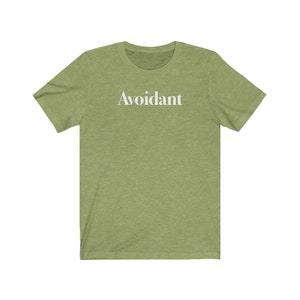 May include: A green t-shirt with the word "Avoidant" printed in white on the front.