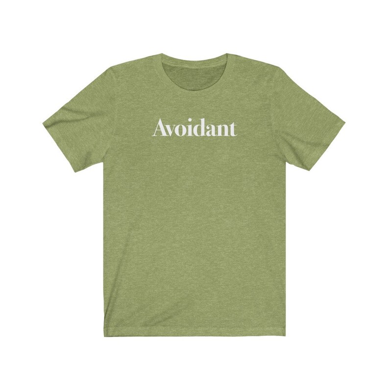 May include: A green t-shirt with the word "Avoidant" printed in white on the front.
