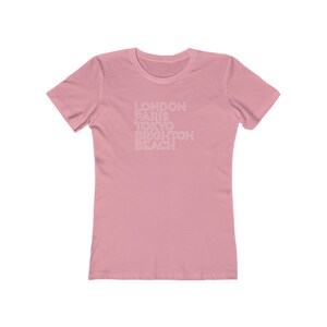 May include: A pink women's t-shirt with the text "LONDON PARIS TOKYO BRIGHTON BEACH" printed in white.